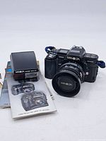 Full set including Minolta 7000 Maxxum camera body, Minolta Maxxum 1600 AF flash unit, and instruction manuals.