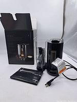 Starbucks Verismo V coffee maker with power cord, water tank, drip tray, instruction manual and original box.