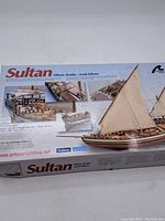 Box showing finished ship model with detailed deck and sail images