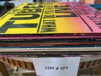 Side view of stacked vinyl albums showing titles and artists including The Tubes, Linda Ronstadt, David Gates, Pat Travers.