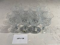 Set of 12 Schott Zwiesel lead crystal glasses arranged in rows on a counter.