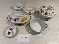 All seven pieces grouped on countertop, pattern and shapes visible