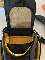 Interior of Lowepro backpack showing yellow padded compartments designed for camera equipment storage