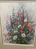 Close-up of the vibrant floral oil painting showing signature and flower details.