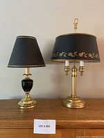 Both lamps placed side by side on a wooden surface showing relative size and appearance.