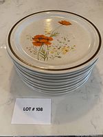 Stack of 10 vintage Haniwa Stoneware dinner plates showing floral design with orange poppies and brown rim accents, displayed on a countertop with lot number card.