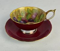 Tea cup on saucer showing angled profile and interior decoration