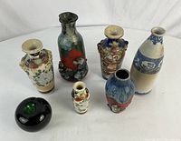 Group photo showing all six vases together with green apple for size reference