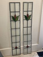 Full view of both narrow stained glass panels side by side showing overall dimensions and design