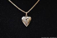 Front view of heart pendant showing accent stones on gold chain
