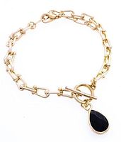 Front view of gold-tone link bracelet with pear cut black gemstone charm