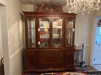 Front view of the full two-piece china cabinet showing upper glass display doors and lower drawers and cupboards