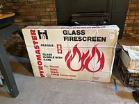 Boxed glass firescreen with Pyromaster branding and fragile warnings.