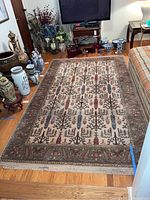 Full view of Karastan area rug laid out in a living room, showing overall pattern and size relative to furniture