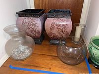 Pair of planters with monkey design, glass vase, bowl, and candleholder grouped together