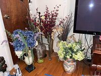 Overview of all five vases arranged with their faux flowers and peacock feathers visible.