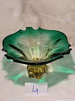 Murano art glass centerpiece showing top and side views with green and yellow gradient glass and ruffled edges.