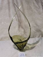 Photo of green Murano glass fruit basket with tall crossed arms and twisted design