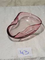 Pink and purple Murano glass centerpiece on white surface, organic curved shape visible