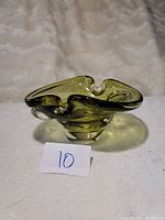 Front and side view of yellow-green vintage Canadian glass bowl showing freeform, wavy rim and thick glass
