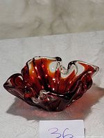 Vintage Murano Italian art glass flower-shaped candy bowl in deep red and clear glass with wavy edges