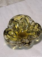Yellow Murano glass flower sculpture viewed from above showing ruffled petals and amber color