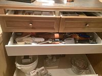 Photo showing Kenwood mixer, two large mixing bowls, and some baking utensils in the drawer including wooden spoons and measuring cups.