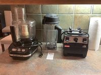 Front view showing KitchenAid food processor and Vita-Mix blender base with blending container