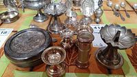 Silver toned decorative small items grouped together showing egg cup, pill box, perfume bottle, spoon, and other pieces