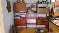 Full view of wall unit showing cabinets, drawers and open shelves with decorative items