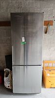 Front view of stainless steel refrigerator with bottom freezer drawer