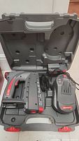 Open carrying case showing Arrow CT50 cordless stapler, battery, and charger inside the molded case.