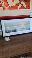Framed signed 'Beaches' black and white panoramic photo by Frank Walls, showing the full frame leaning against a wall.