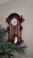 Full view of Ridgeway ornate carved wooden wall clock with glass and decorative gold design