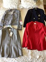 All four jackets laid out on bed