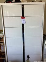 Front view of white enamel metal dresser showing all drawers closed