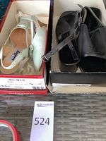 Two shoeboxes side by side showing the black platform sandals and mint green pumps