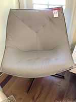 Full front view of chair showing overall shape and upholstery