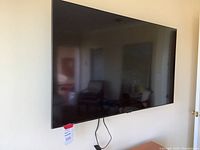 Front view of wall-mounted 55-inch Samsung flat-panel TV