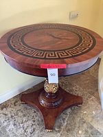 Full view of round table showing top inlay pattern and pedestal base
