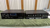 Front view of Fisher stereo amplifier CA-276 (left) and double cassette deck CR-W80 (right) on a green towel.