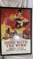 Front view of framed 'Gone with the Wind' movie poster showing full artwork and visible frame wear.