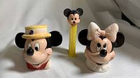 Front view of Mickey Mouse PEZ dispenser and Minnie and Mickey salt and pepper shakers.