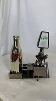 Front view of metal decor showing Coca-Cola bottle and Fresca soda dispenser with clear logo and details.