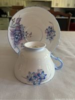 Cup and saucer set showing floral decoration and scalloped edges