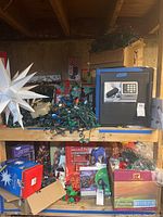 Overview of lot showing large white star light, mixed holiday lights, and night star projector. Safe visible but not included.