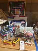 Overview of Dept 56 Flamingo Motel, Lemax Plymouth Bus Station with boxes and two Ertl model buses.