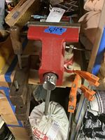 Red vintage woodworking vise attached to a workbench with a 5.5 inch jaw measurement label visible.