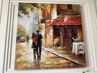 Full view of the romantic art print showing a couple walking down a rainy street by a café.