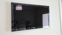 Front view of mounted TV with black bezel